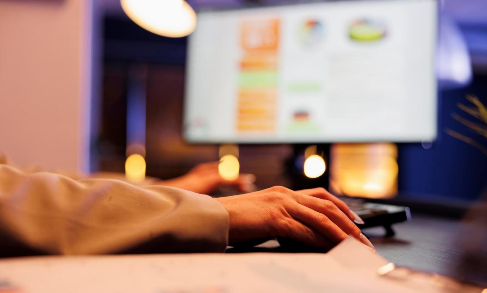 Professional analyzing data charts on multiple screens